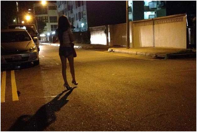 Girl Walking At night on Road Side For Customer